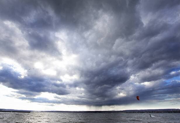 March 16, 2016 - Hamilton, ON, CAN - Kristian Wolf, 29, of Burlington, takes advantage of the warmer weather and high afternoon winds to kite board on Hamilton Harbour in Hamilton, Ontario on March 16, 2016. Kite Boarding Hamilton Harbour - ZUMAp131