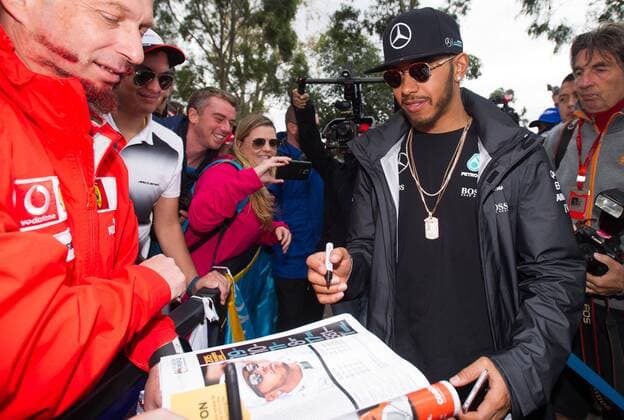 (160319) -- MELBOURNE, March 19, 2016 -- Mercedes AMG Petronas Formula One driver Lewis Hamilton(R) of Britain autographs for fans before the third practice session ahead of the Australian Formula One Grand Prix in Melbourne, Australia, March 19, 2016. The Australian Formula One Grand Prix will take place in Melbourne on March 20. ) (SP)AUSTRALIA-MELBOURNE-F1-THIRD PRACTICE SESSION BaixXue 