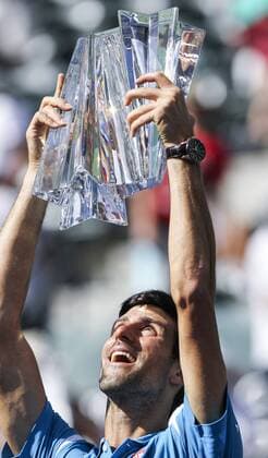(160321) -- INDIAN WELLS, March 20, 2016 -- Novak Djokovic of Serbia celebrates with the trophy after winning Milos Raonic of Canada during the men singles final match of the BNP Paribas Open tennis tournament in Indian Wells, California in the United States, on March 20, 2016. Djokovic won 6-4, 6-4. Zhao Hanrong) (SP)U.S.-CALIFORNIA ATP Tennis Herren BNP PARIBAS OPEN-FINAL yanglei 