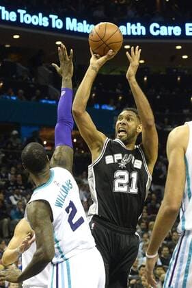 March 21, 2016 - Charlotte, USA - San Antonio Spurs center Tim Duncan shoots the ball over Charlotte Hornets forward Marvin Williams during Monday night s game at Time Warner Cable Arena on March 21, 2016 in Charlotte, N.C. The Charlotte Hornets defeated the San Antonio Spurs 91-88. Hornets beat Spurs 91-88 - ZUMAm67_