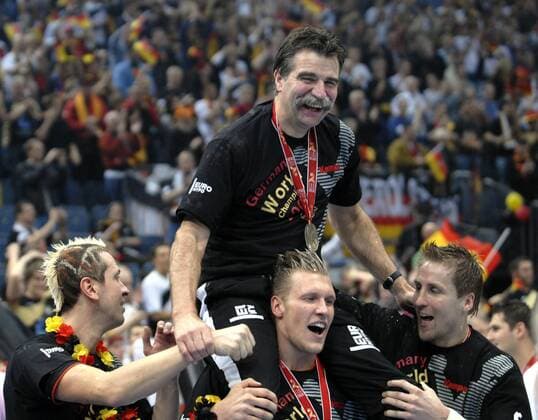 Handball WM 2007 Finale: Deutschland-Polen 04.02.2007. Die Deutsche Mannschaft mit der WM Trophäe. Bundestr. Heiner Brand auf den Schultern von Lars Kaufmann. Li.: Hens. re: Roggisch. HM
