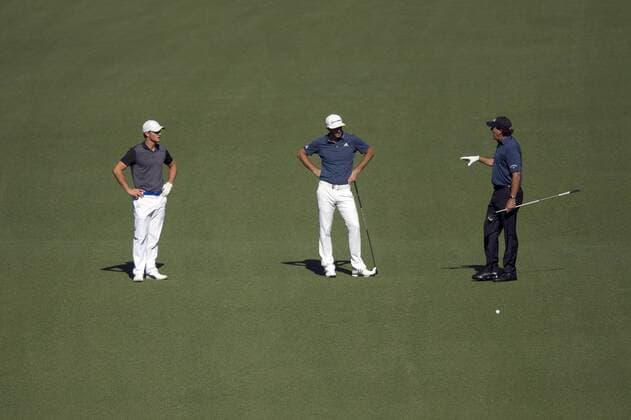 Phil Mickelson (R), Dustin Johnson (C) and Bryson DeChambeau talk on the 7th fairway during a practice round before the 2016 Masters Tournament at Augusta National in Augusta, Georgia on April 5, 2016.  AUG20160405308 KEVINxDIETSCH