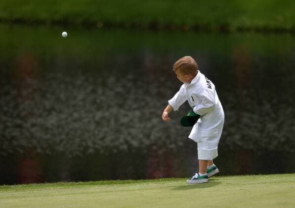 Bubba Watson s son, Caleb, throws his ball into the water on the ninth hole during the Par Three Contest at the 2016 Masters Tournament at Augusta National in Augusta, Georgia on April 6, 2016.  AUG20160406307 KEVINxDIETSCH