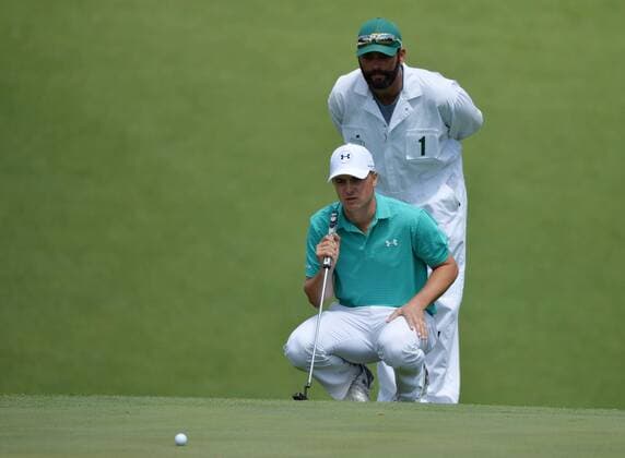 Caddie Michael Greller and Jordan Spieth line up a putt on the 10th hole in the first round of the 2016 Masters Tournament at Augusta National in Augusta, Georgia on April 7, 2016.  MAS20160407151 KEVINxDIETSCH