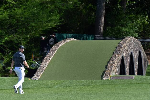 Rory McIlroy of Northern Ireland walks to Hogan s Bridge on the 12th hole in the first round of the 2016 Masters Tournament at Augusta National in Augusta, Georgia on April 7, 2016.  AUG20160407302 KEVINxDIETSCH