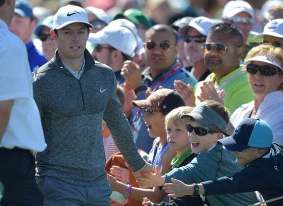 Children reach out for the hand Rory McIlroy of North Ireland before he tees off on the first hole in the second round of the 2016 Masters Tournament at Augusta National in Augusta, Georgia on April 8, 2016.  MAS20160408101 KEVINxDIETSCH