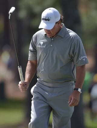Phil Mickelson reacts as he walks to the green after hitting a shot from a green side bunker that eventually lands back in the sand on the 7th hole in the second round of the 2016 Masters Tournament at Augusta National in Augusta, Georgia on April 8, 2016. Tom Watson announced that this 2016 Masters will be his last.  MAS20160408143 KEVINxDIETSCH