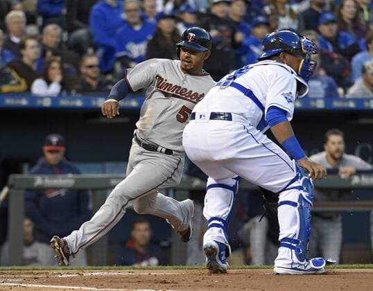 April 8, 2016 - Kansas City, MO, USA - The Minnesota Twins Eduardo Escobar scores on a hit by Kurt Suzuki behind Kansas City Royals catcher Salvador Perez in the second inning on Friday, April 8, 2016, at Kauffman Stadium in Kansas City, Mo. Minnesota at Kansas City - ZUMAm67_