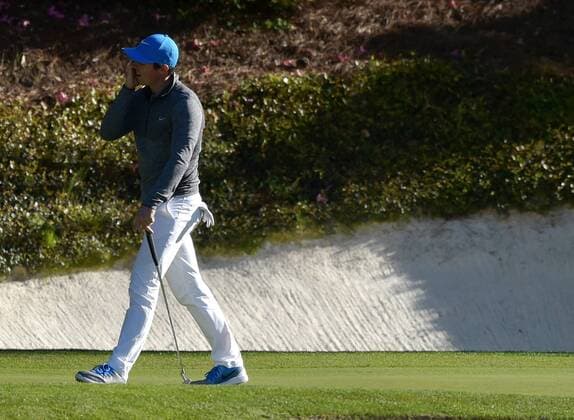 Rory McIlroy of Northern Ireland reacts after missing a birdie putt on the 12th hole in the third round of the 2016 Masters Tournament at Augusta National in Augusta, Georgia on April 9, 2016.  MAS20160409144 KEVINxDIETSCH