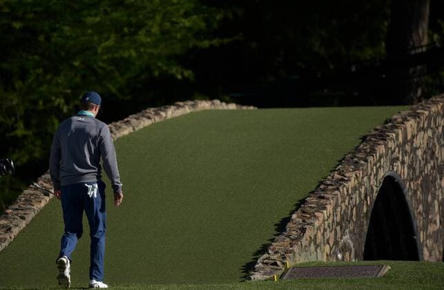 Jordan Spieth walks over the Hogan Bridge to the 12th green in the third round of the 2016 Masters Tournament at Augusta National in Augusta, Georgia on April 9, 2016.  MAS20160409140 KEVINxDIETSCH