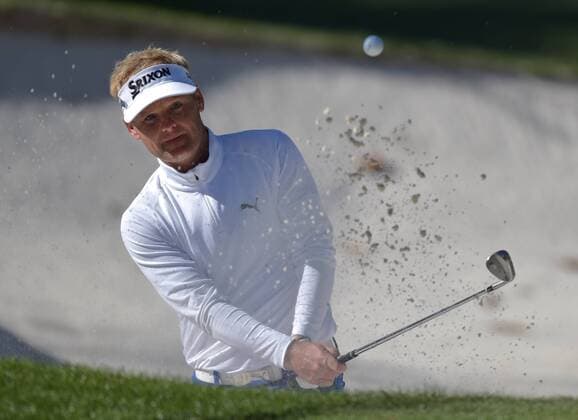 Soren Kjeldsen of Denmark hits out of a bunker on the 10th hole in the third round of the 2016 Masters Tournament at Augusta National in Augusta, Georgia on April 9, 2016.  MAS20160409150 KEVINxDIETSCH