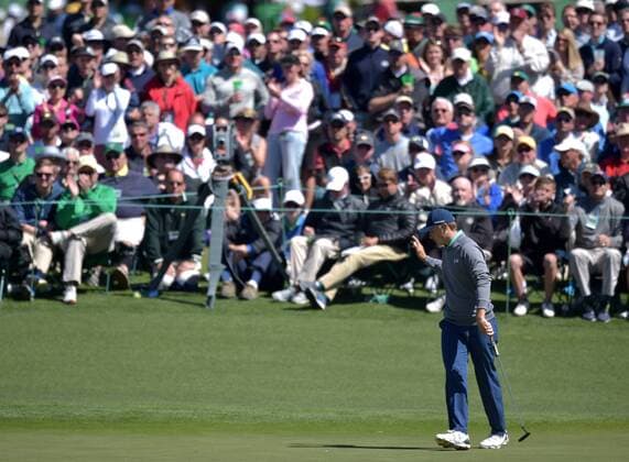Fans watch Jordan Spieth react after making a putt for birdie on the 2nd hole in the third round of the 2016 Masters Tournament at Augusta National in Augusta, Georgia on April 9, 2016.  MAS20160409155 KEVINxDIETSCH