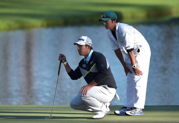 Hideki Matsuyama of Japan and caddie Daisuke Shindo line up a putt on the 16th hole in the third round of the 2016 Masters Tournament at Augusta National in Augusta, Georgia on April 9, 2016.  MAS20160409175 KEVINxDIETSCH