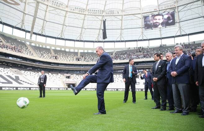 Besiktas football club s new stadium Vodafone Arena opening day in Istanbul , Turkey , on April 10 , 2016. Pictured: Turkish President Recep Tayyip Erdogan (R) kicks the ball next to former Turkish President Abdullah Gul (L) on April 10, 2016 in Istanbul during Besiktas football club s Vodafone Arena new stadium on the opening day 