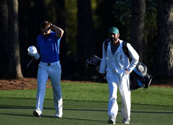 Caddie Michael Greller walks with Jordan Spieth who reacts walking to the 18th green in the final round of the 2016 Masters Tournament at Augusta National in Augusta, Georgia on April 10, 2016. Spieth lost control of the round after making a score of 7 on the par 3 12th hole knocking 2 balls into the water and failed to repeat as Masters champion. Danny Willett won in his second Masters and he became the first player from England to win the green jacket since Nick Faldo in 1996.  MAS20160410141 KEVINxDIETSCH