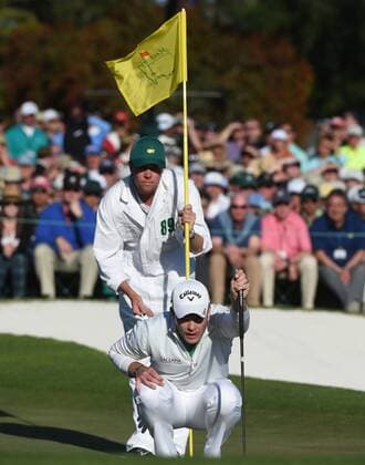 Danny Willett of England and caddie Jonathan Smart line up a putt on the 18th hole before posting a score of 5 under par in the final round of the 2016 Masters Tournament at Augusta National in Augusta, Georgia on April 10, 2016. Danny Willett won in his second Masters and he became the first player from England to win the green jacket since Nick Faldo in 1996.  MAS20160410153 KEVINxDIETSCH