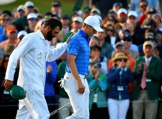 April 10, 2016 - Augusta, GA, USA - Caddie Michael Greller, left, pats Jordan Spieth, right, on the back as they exit the 18th green during the final round of the Masters on Sunday, April 10, 2016, at Augusta National Golf Club in Augusta, Ga. Masters final round - ZUMAm67_