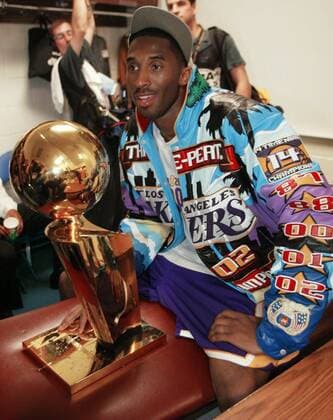 Kobe Bryant June 12, 2002 - Los Angeles Kobe Bryant holds the NBA championship trophy in the Lakers locker room following their win over New Jersey Nets in game four of the NBA Championship on Wednesday, June 12, 2002, at the Meadowlands, in East Rutherford, New Jersey. Kobe Bryant Final Laker Home Game - ZUMAm67_