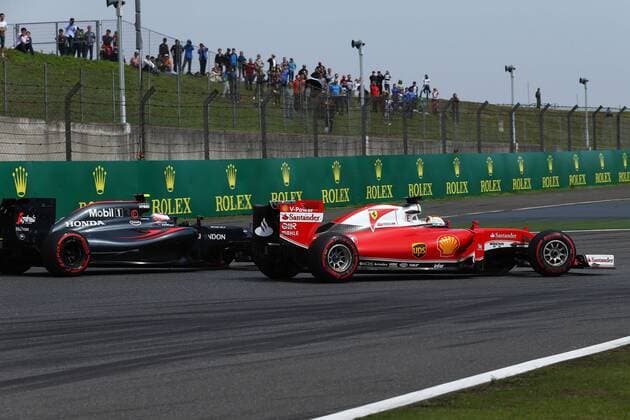 Chinese Grand Prix, Shanghai 14 - 17 April 2016 17.04.2016 - Race, Jenson Button (GBR) McLaren Honda MP4-31 and Sebastian Vettel (GER) Scuderia Ferrari SF16-H 