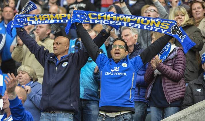 17.04.2016. King Power Stadium, Leicester, England. Barclays Premier League. Leicester City versus West Ham. Leicester City fans wave Champions scarfs and celebrate to show their support after their team come back to draw 2-2. xAndyxThompsonx  ActionPlus11729359