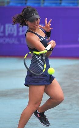 Riko Sawayanagi of Japan returns a shot to Xu Shilin of China in their women s singles match during the 2016 ITF Women s Circuit - Nanning in Nanning city, south China s Guangdong province, 21 April 2016. Xu Shilin was defeated by Riko Sawayanagi 1-2 (3-6, 6-0, 3-6). Riko Sawayanagi eliminates Xu Shilin at ITF Women s Circuit - Nanning  pbu434959_04
