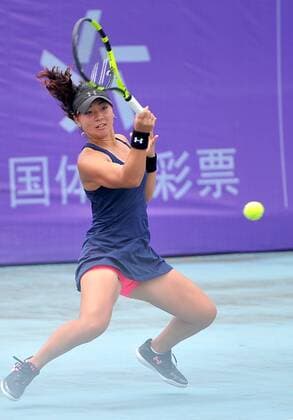 Riko Sawayanagi of Japan returns a shot to Xu Shilin of China in their women s singles match during the 2016 ITF Women s Circuit - Nanning in Nanning city, south China s Guangdong province, 21 April 2016. Xu Shilin was defeated by Riko Sawayanagi 1-2 (3-6, 6-0, 3-6). Riko Sawayanagi eliminates Xu Shilin at ITF Women s Circuit - Nanning  pbu434959_01