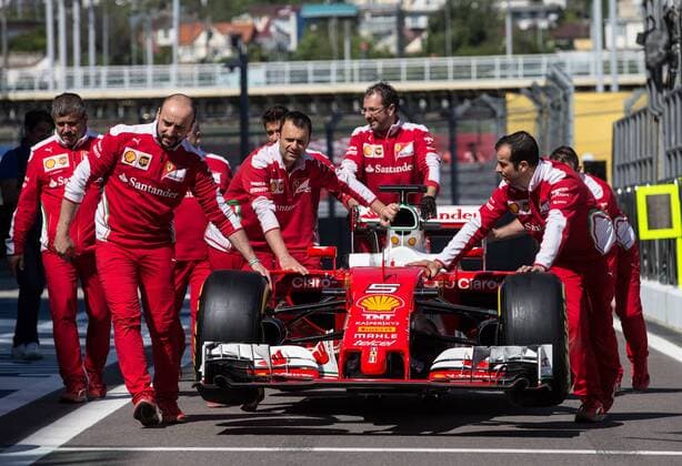 SOCHI, RUSSIA. APRIL 28, 2016. Scuderia Ferrari F1Team mechanics with a racing car at the Sochi Autodrom racing circuit ahead of the 2016 Formula 1 Russian Grand Prix. Sergei Savostyanov TASS  TS021250