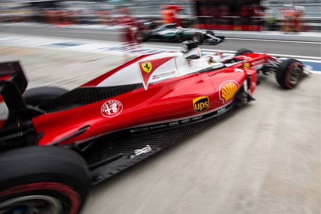 SOCHI, RUSSIA. APRIL 30, 2016. Ferrari driver Sebastian Vettel of Germany (front) leaves the pits as Mercedes driver Lewis Hamilton (back) steers his car in the third practice session of the 2016 Formula One Russian Grand Prix at the Sochi Autodrom Circuit. Sergei Savostyanov TASS  TS021563