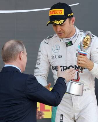 SOCHI, RUSSIA. MAY 1, 2016. Russia s President Vladimir Putin (L) and German driver Nico Rosberg of the Mercedes AMG Petronas F1 team, the winner of the 2016 Formula 1 Russian Grand Prix, at an awards ceremony, at the Sochi Autodrom Circuit in Olympic Park. Sergei Savostyanov TASS  TS0217D7