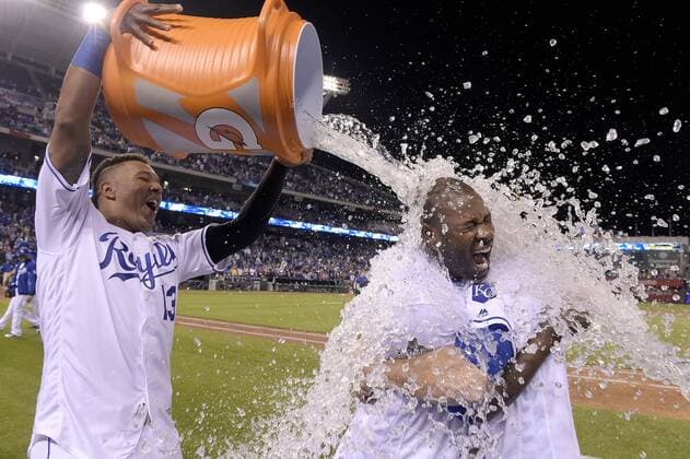 May 3, 2016 - Kansas City, MO, USA - The Kansas City Royals Lorenzo Cain and Mike Moustakas hold onto each other as Salvador Perez delivers an icy shower after a 7-6 win against the Washington Nationals on Tuesday, May 3, 2016, at Kauffman Stadium in Kansas City, Mo. Washington at Kansas City - ZUMAm67_