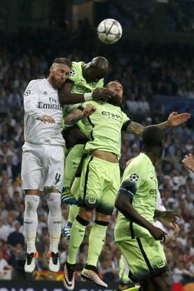 Real Madird s defenses Sergio Ramos (L) jumps for the ball with Manchester City s Argentinian Nicolas Otamendi (2R) and Ivorian Toure Yaya (2L) during a Champions League semifinal second leg match between Real Madrid and Manchester City at Santiago Bernabeu stadium in Madrid, Spain, 4 May 2016. REAL MADRID VS MANCHESTER CITY !ACHTUNG: NUR REDAKTIONELLE NUTZUNG!  MAD027 20160504-635979957995845772