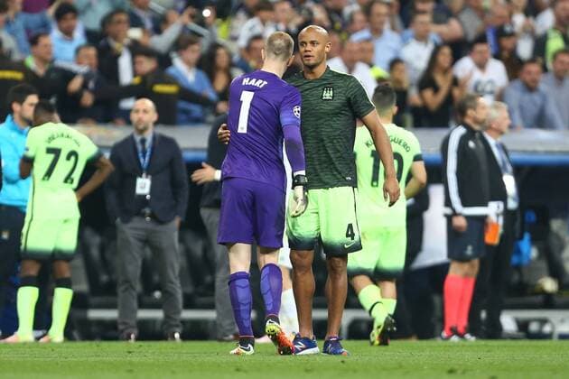 Vincent Kompany of Manchester City consoles Joe Hart during the UEFA Champions League Semi Final 2nd leg match at the Santiago Bernabeu stadium. Photo credit should read: Philip Oldham Sportimage EDITORIAL USE ONLY. No use with unauthorised audio, video, data, fixture lists, club league logos or live services. Online in-match use limited to 120 images, no video emulation. No use in betting, games or single club league player publications.