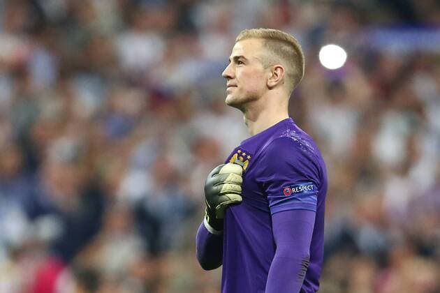 Joe Hart of Manchester City holds the club crest on his shirt during the UEFA Champions League Semi Final 2nd leg match at the Santiago Bernabeu stadium. Photo credit should read: Philip Oldham Sportimage EDITORIAL USE ONLY. No use with unauthorised audio, video, data, fixture lists, club league logos or live services. Online in-match use limited to 120 images, no video emulation. No use in betting, games or single club league player publications.