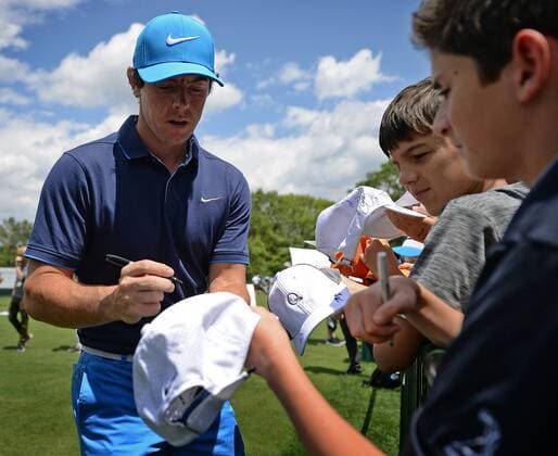 May 4, 2016 - Charlotte, NC, USA - Rory McIlroy, left, stops to sign autographs for fans at the practice range at Quail Hollow Club in Charlotte, N.C., on Wednesday, May 4, 2016. Wells Fargo Pro-Am - ZUMAm67_