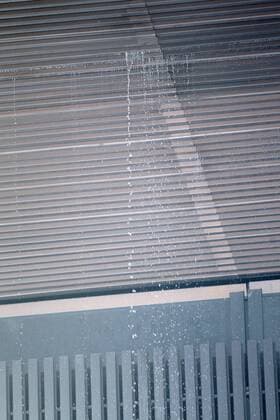 A cascade of water seeps through the roof of the Principal Court on the Caja Magica (Magic Box) during Madrid Open Tennis 2016 match.May, 6, 2016.  (20160506139)