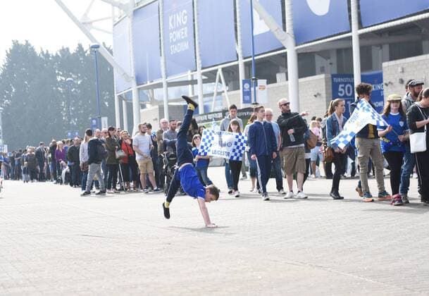 A Leicester City fan cartwheels as fans queue for the new Leicester shirt before the Barclays Premier League match at the King Power Stadium Leicester. Photo credit should read: Nathan Stirk Sportimage - Newcastle Utd vs Tottenham - St James Park Stadium - Newcastle Upon Tyne - England - 19th April 2015 - Picture Phil Oldham Sportimage EDITORIAL USE ONLY. No use with unauthorised audio, video, data, fixture lists, club league logos or live services. Online in-match use limited to 120 images, no video emulation. No use in betting, games or single club league player publications.