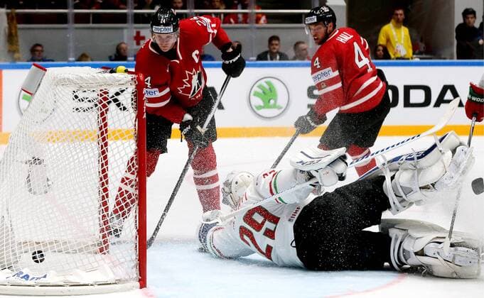 ST. PETERSBURG, RUSSIA. MAY 8, 2016. Hungary s goalie Zoltan Hetenyi (C) concedes a goal in their 2016 IIHF World Championship WM Weltmeisterschaft Preliminary Round Group B Ice hockey Eishockey match against Canada at the Yubileyny Sports Palace. Pictured L is Canada s Corey Perry and R id Canada s Taylor Hall. Alexander Demianchuk TASS  TS021FDF