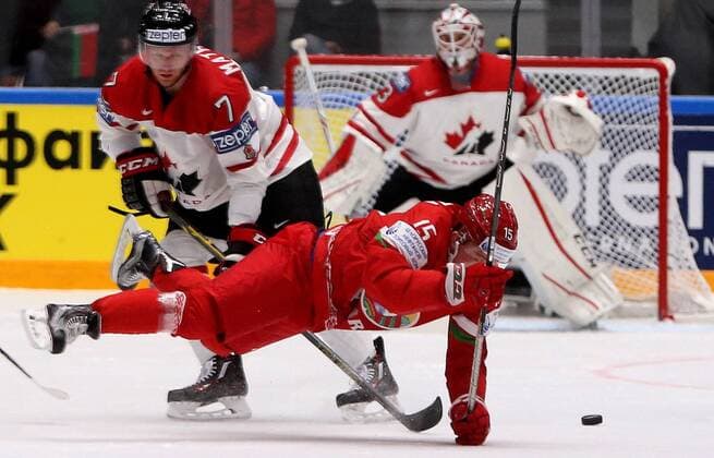 ST. PETERSBURG, RUSSIA. MAY 9, 2016. Canada s Michael Matheson and Belarus Artyom Demkov (L-R front) fight for the puck in their 2016 IIHF World Championship WM Weltmeisterschaft Preliminary Round Group B Ice hockey Eishockey match at the Yubileyny Sports Palace. Alexander Demianchuk TASS  TS022379