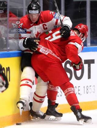 ST. PETERSBURG, RUSSIA. MAY 9, 2016. Canada s Corey Perry (L) and Belarus Roman Dyukov fight for the puck in their 2016 IIHF World Championship WM Weltmeisterschaft Preliminary Round Group B Ice hockey Eishockey match at the Yubileyny Sports Palace. Alexander Demianchuk TASS  TS02237B