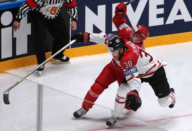 ST. PETERSBURG, RUSSIA. MAY 9, 2016. Canada s Boone Jenner (front) and Belarus Artur Gavrus fight for ther puck in their 2016 IIHF World Championship WM Weltmeisterschaft Preliminary Round Group B Ice hockey Eishockey match at the Yubileyny Sports Palace. Team Canada won the game 8-0. Sergei Savostyanov TASS  TS02239F