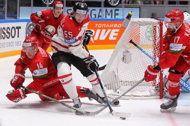ST. PETERSBURG, RUSSIA. MAY 9, 2016. Belarus Yevgeny Lisovets (L), Alexei Kalyuzhny (R) and Canada s Mark Scheifele (C) fight for the puck in their 2016 IIHF World Championship WM Weltmeisterschaft Preliminary Round Group B Ice hockey Eishockey match at the Yubileyny Sports Palace. Team Canada won the game 8-0. Alexander Demianchuk TASS  TS022420