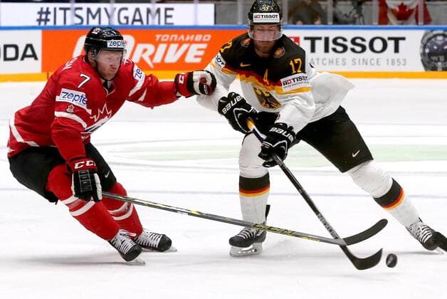 ST. PETERSBURG, RUSSIA. MAY 12, 2016. Canada s Michael Matheson (L) and Germany s Marcus Kink fight for the puck in their 2016 IIHF World Championship WM Weltmeisterschaft Preliminary Round Group B Ice hockey Eishockey match at Yubileyny Sports Palace. Team Canada won the game 5:2. Alexander Demianchuk TASS  TS022B52