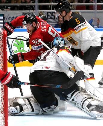 ST. PETERSBURG, RUSSIA. MAY 12, 2016. Canada s Ryan O Reilly, Germany s goalie Timo Pielmeier and Germany s Korbinian Holzer (L-R) in action in their 2016 IIHF World Championship WM Weltmeisterschaft Preliminary Round Group B Ice hockey Eishockey match at Yubileyny Sports Palace. Team Canada won the game 5:2. Alexander Demianchuk TASS  TS022B55