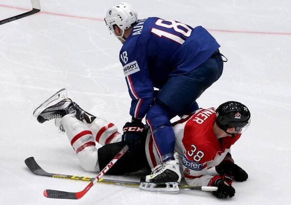 ST. PETERSBURG, RUSSIA. MAY 16, 2016. France s Yohann Auvitu (top) and Canada s Boone Jenner in action in their 2016 IIHF World Championship WM Weltmeisterschaft Preliminary Round Group B Ice hockey Eishockey match at Yubileyny Sports Palace. The Canadian Team won the game 4:0. Alexander Demianchuk TASS  TS0233C9