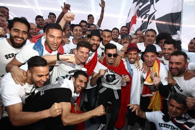 Besiktas players arrive at their stadium during celebrations after their team won the Turkish Super Toto league football match between Besiktas and Osmanlispor at the Vodafone Arena Stadium in Istanbul on May 19, 2016. .Istanbul side Besiktas on May 15 clinched the Turkish Super Lig title with a game to spare, topping the league for the first time since 2009 and claiming Turkey s sole automatic Champions League spot. Besiktas won the match 3-1. Pictured : Mario Gomez 