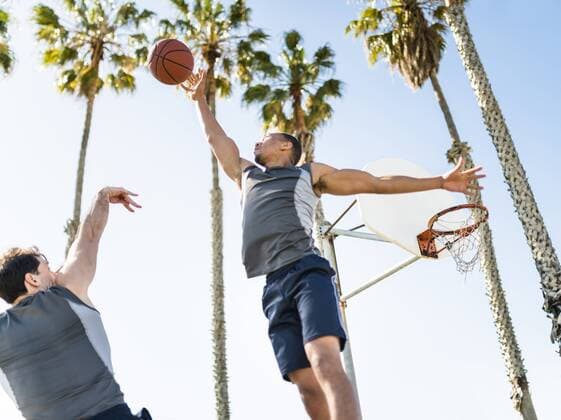 Two young men playing basketball on an outdoor court model released Symbolfoto  LEF000107