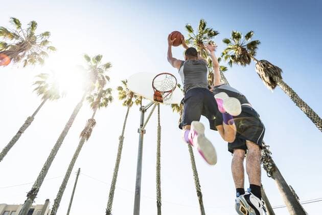 Two young men playing basketball on an outdoor court model released Symbolfoto  LEF000108