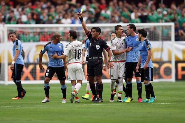 05 June 2016: Uruguay midfielder Carlos Sanchez 5 reacts after being given a yellow card by referee Enriquee Caceres (center) during the first half of the Copa America Centanario game against Mexico at University of Phoenix Stadium in Glendale, Az. (Photo by Chris Coduto Icon Sportswire) SOCCER: JUN 05 Copa America Centenario - Mexico v Uruguay Icon3171606050513 EDITORIAL USE ONLY