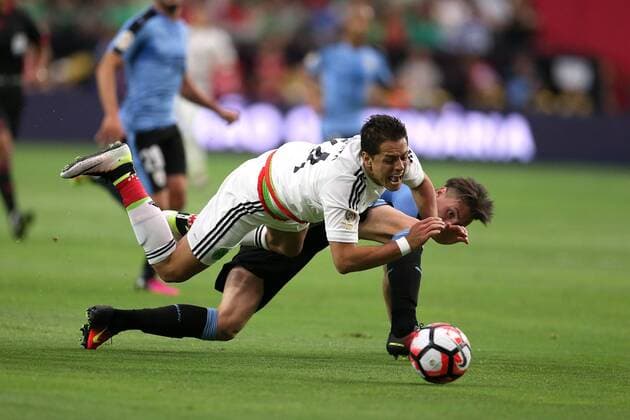 05 June 2016: Mexico forward Javier Hernandez 14 trips over Uruguay defender Jose Gimenez 2 during the second half of the Copa America Centanario game at University of Phoenix Stadium in Glendale, Az. Mexico won 3-1. (Photo by Chris Coduto Icon Sportswire) SOCCER: JUN 05 Copa America Centenario - Mexico v Uruguay Icon3171606050996 EDITORIAL USE ONLY
