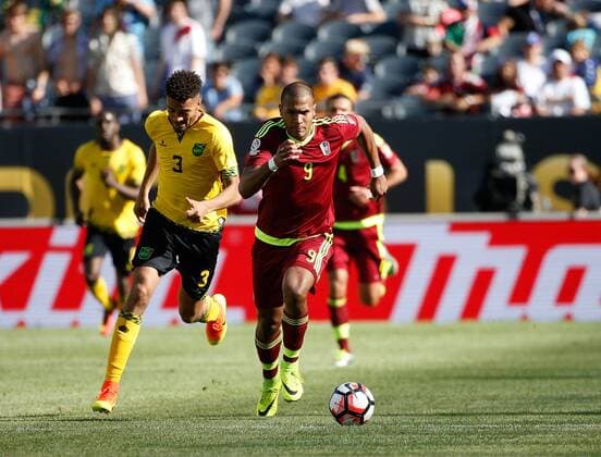 Venezuela forward Jose Salomon Rondon (L) and Jamaica defender Michael Hector chase after the ball during the second half of a 2016 Copa America Centenario Group C match at Soldier Field in Chicago on June 5, 2016. Venezuela defeated Jamaica 1-0.  CHI2016060526 BRIANxKERSEY